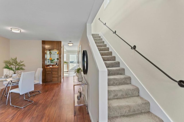 stairs featuring hardwood / wood-style flooring