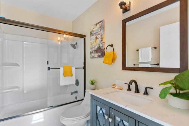 full bathroom featuring toilet, enclosed tub / shower combo, and vanity