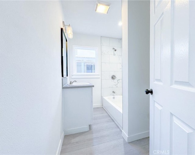 bathroom with tiled shower / bath and vanity