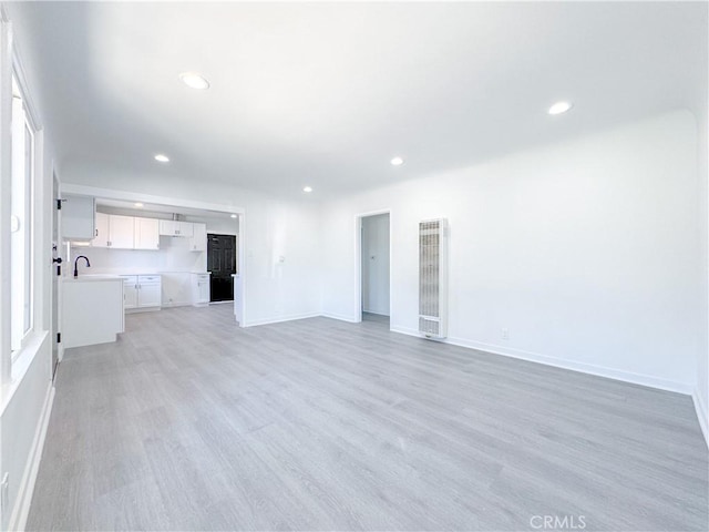 unfurnished living room featuring light hardwood / wood-style floors