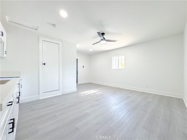 empty room featuring ceiling fan and light hardwood / wood-style floors