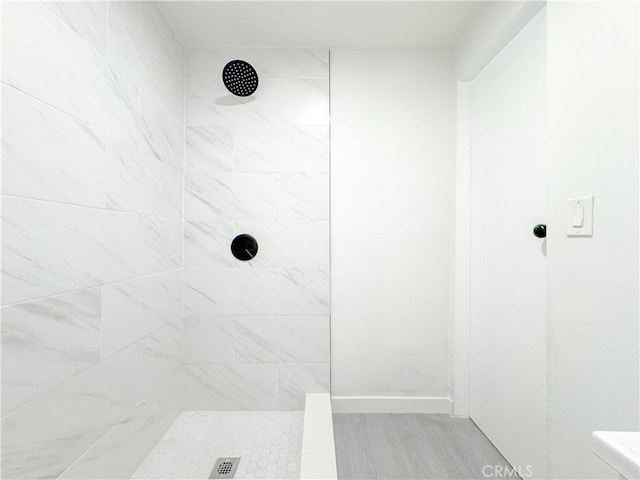 bathroom with a tile shower