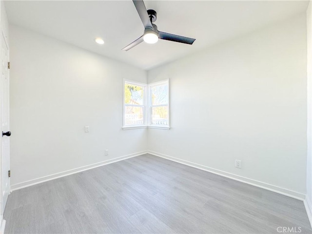 empty room with ceiling fan and wood-type flooring