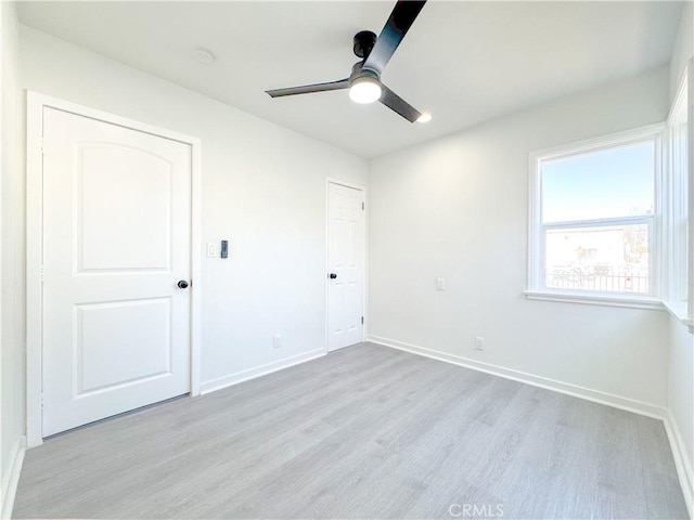 interior space with ceiling fan and light hardwood / wood-style flooring