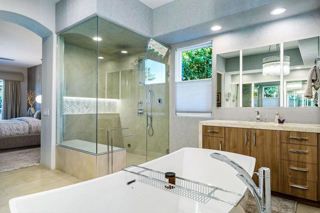 bathroom with vanity and independent shower and bath