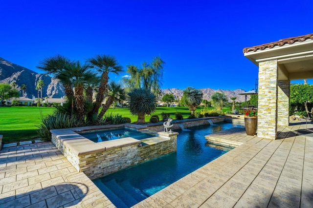 view of swimming pool featuring a patio, a yard, an in ground hot tub, and a mountain view