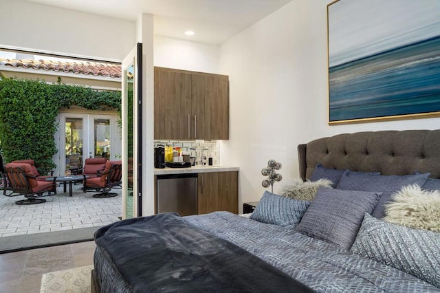 bedroom with french doors and refrigerator