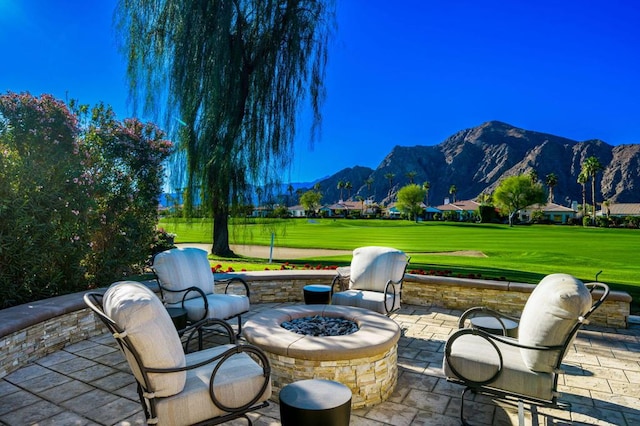 view of patio featuring a fire pit and a mountain view