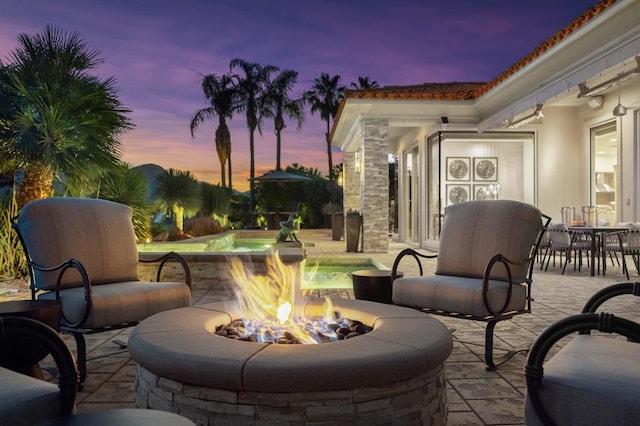 patio terrace at dusk with a fire pit