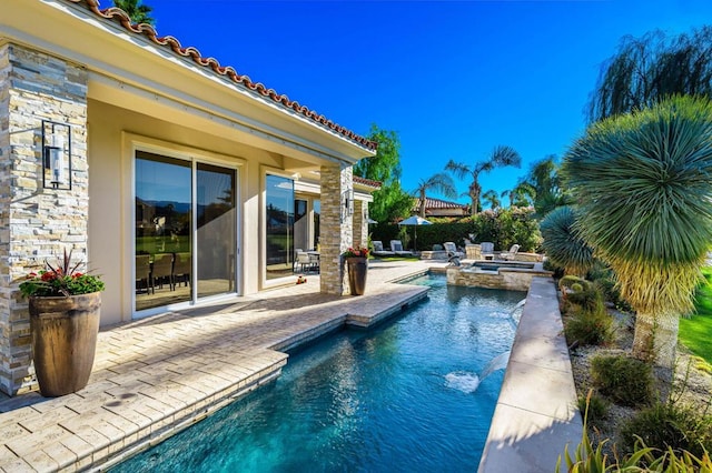 view of pool with a patio and an in ground hot tub