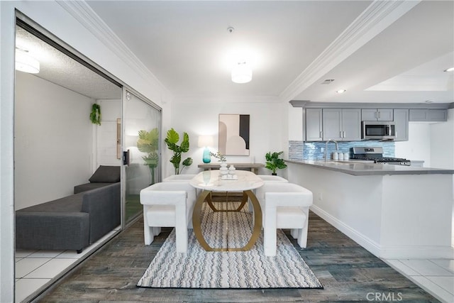 dining space featuring dark wood-type flooring and ornamental molding