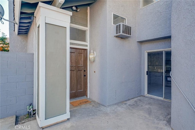 property entrance featuring an AC wall unit