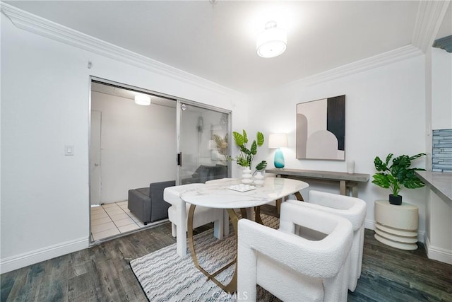 dining area with dark wood-type flooring and crown molding