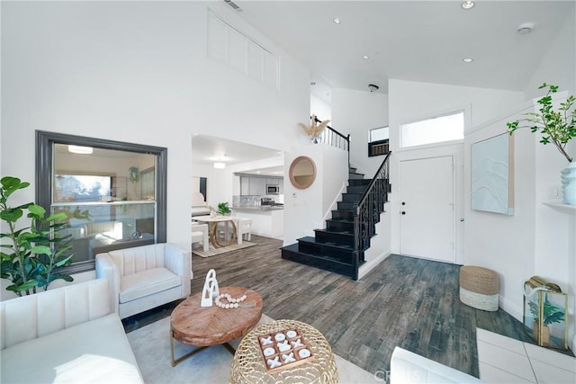 living room with hardwood / wood-style flooring and high vaulted ceiling