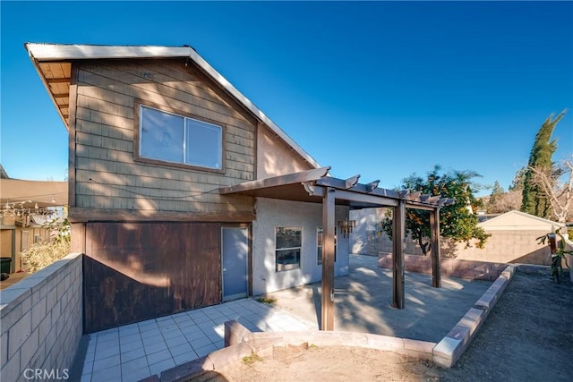 view of front of home with a patio area and a pergola