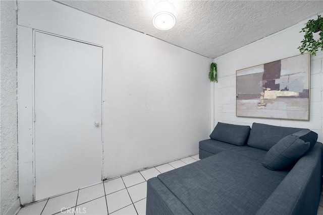 tiled living room with a textured ceiling