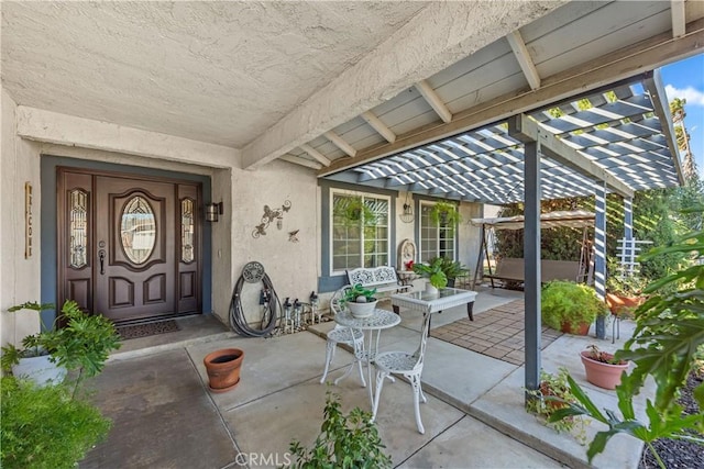 property entrance featuring a pergola