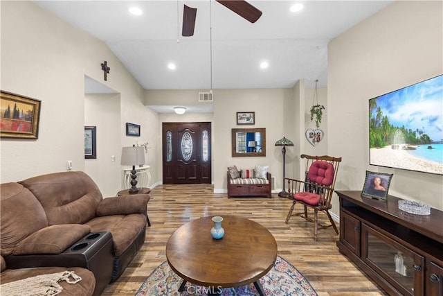 living room with lofted ceiling, light wood-type flooring, and ceiling fan