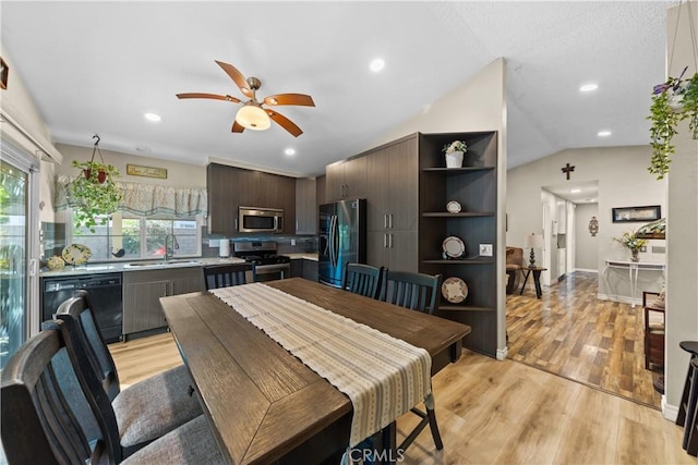 dining area with lofted ceiling, ceiling fan, light hardwood / wood-style floors, and sink