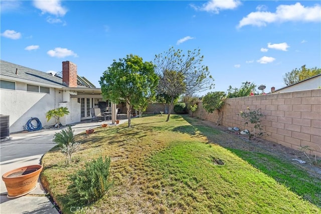 view of yard featuring a patio area, french doors, and cooling unit