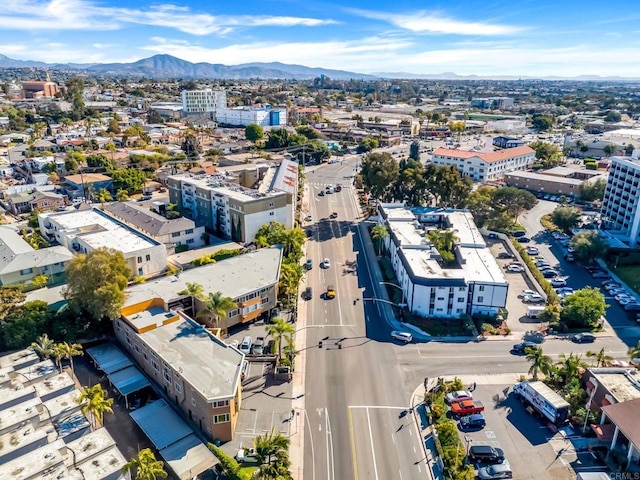 drone / aerial view featuring a mountain view and a city view