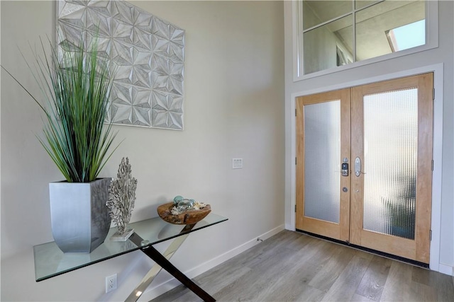 entryway with light hardwood / wood-style flooring and french doors