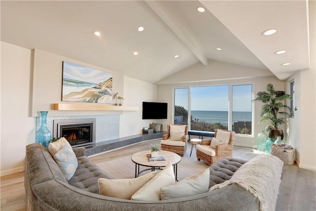 living room with vaulted ceiling with beams and light wood-type flooring