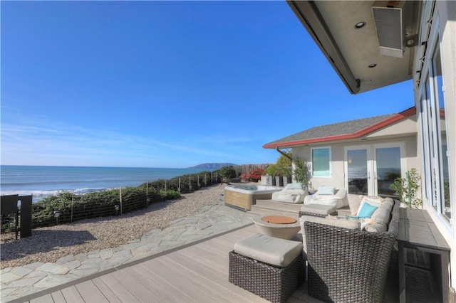 wooden deck featuring outdoor lounge area and a water view