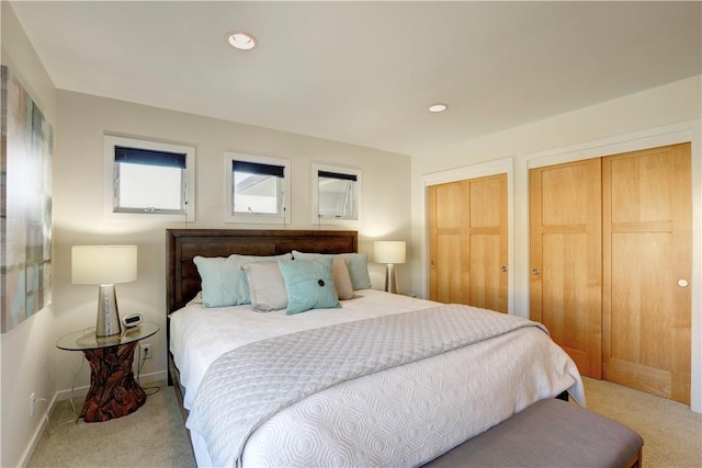 carpeted bedroom with multiple closets