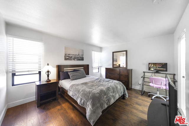 bedroom featuring dark hardwood / wood-style flooring