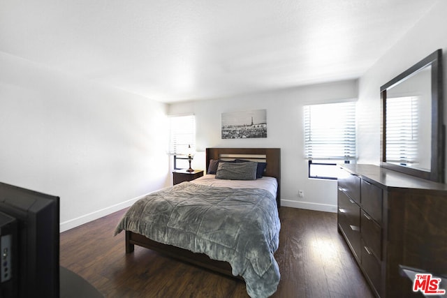 bedroom featuring dark hardwood / wood-style flooring