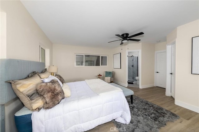 bedroom featuring ceiling fan, ensuite bath, and hardwood / wood-style flooring