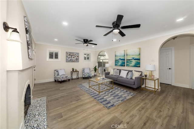 living room featuring wood-type flooring and ceiling fan