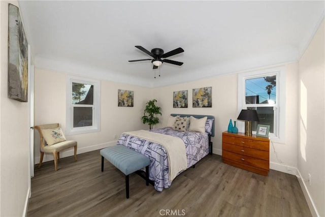 bedroom with ceiling fan and dark hardwood / wood-style floors