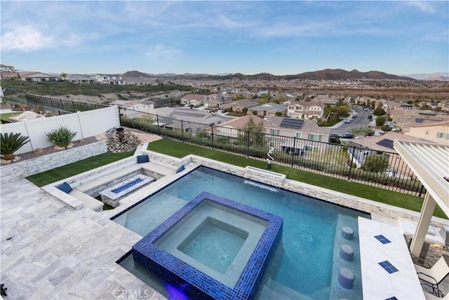 view of swimming pool with a mountain view, a patio, and an in ground hot tub