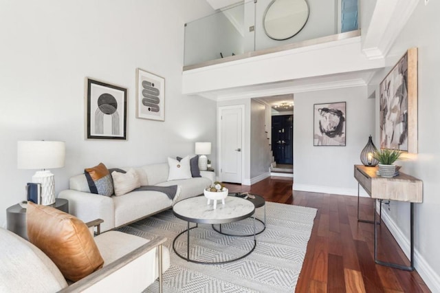 living room with a high ceiling and dark hardwood / wood-style floors