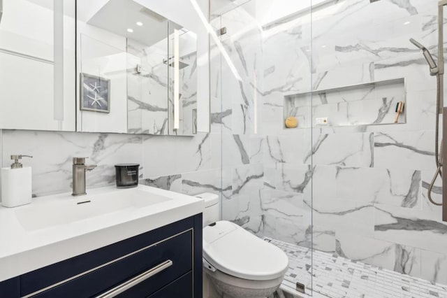 bathroom with tile walls, tasteful backsplash, toilet, a shower with shower door, and vanity