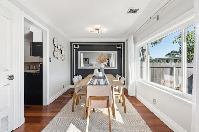 dining space featuring ornamental molding and dark hardwood / wood-style flooring