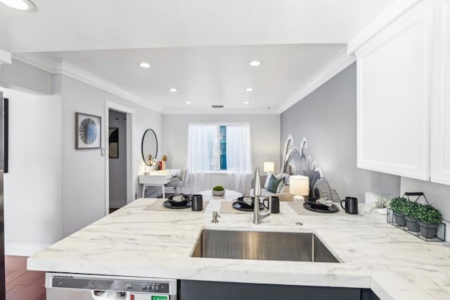 kitchen with crown molding, dishwasher, sink, dark wood-type flooring, and light stone counters