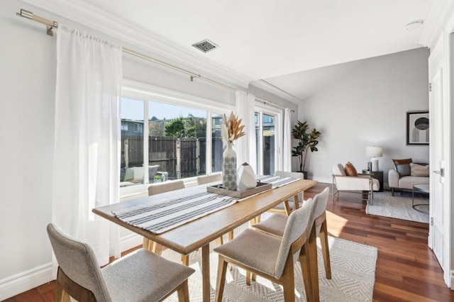 dining area with crown molding and dark hardwood / wood-style flooring