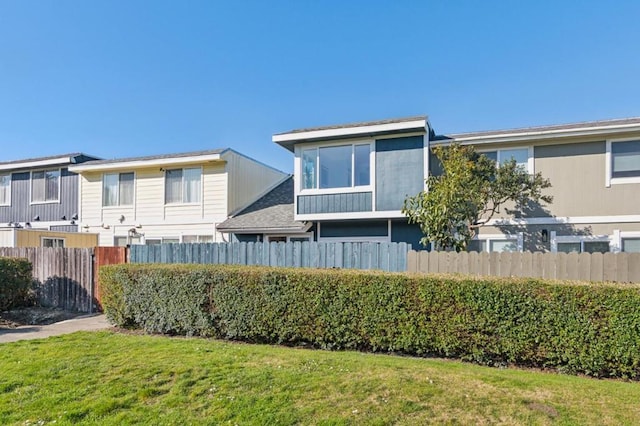 rear view of house with a yard