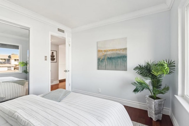 bedroom with dark wood-type flooring and ornamental molding