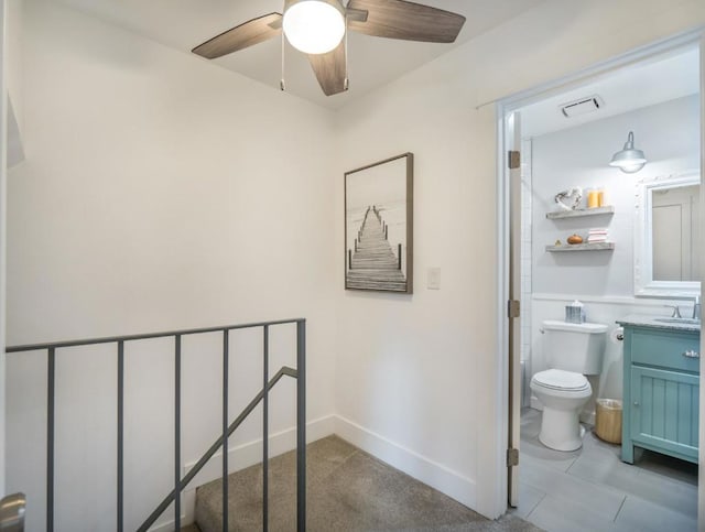 bathroom with ceiling fan, vanity, and toilet