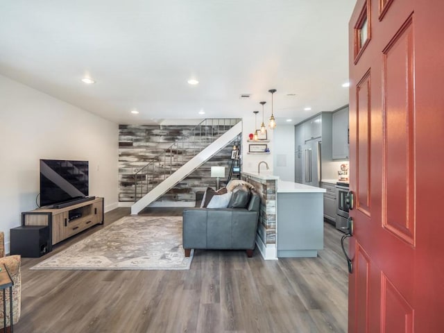 living room featuring hardwood / wood-style flooring and sink