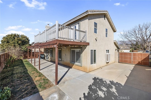 back of property featuring a patio area and a deck