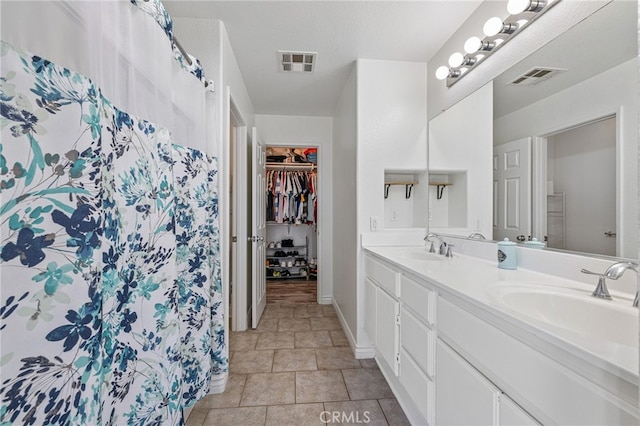 bathroom featuring vanity, a shower with curtain, and a textured ceiling