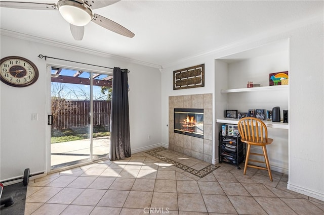 living room with built in shelves, a fireplace, ornamental molding, ceiling fan, and light tile patterned floors