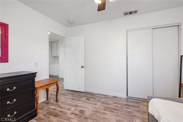 bedroom with ceiling fan, a closet, and light wood-type flooring