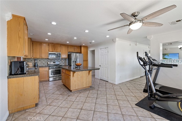 kitchen featuring a kitchen bar, appliances with stainless steel finishes, tasteful backsplash, crown molding, and a center island