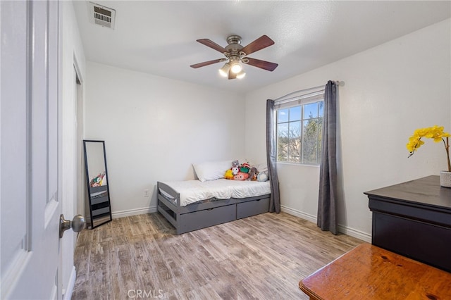 bedroom with ceiling fan and light wood-type flooring